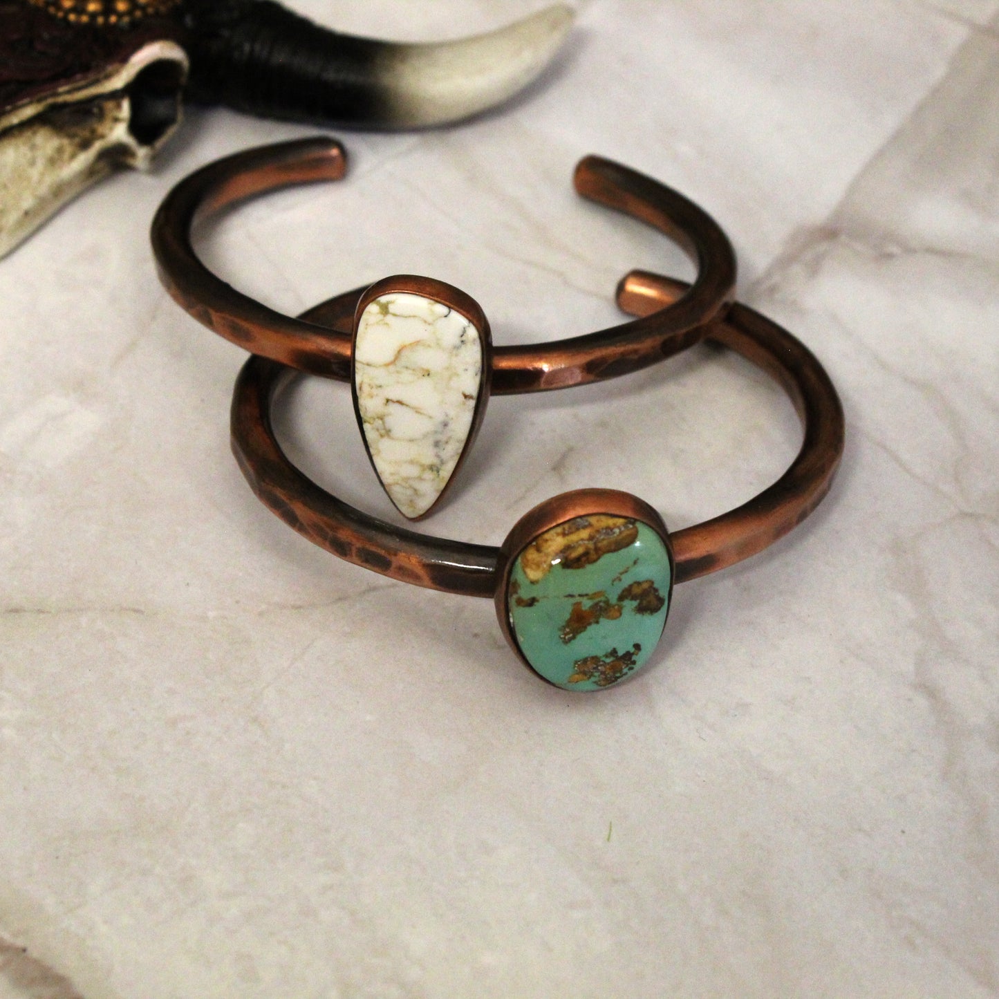 Explore our stunning oxidized copper bracelets adorned with genuine turquoise stones. Handcrafted in the USA, these pieces are ideal for layering and lasting beauty. Bends slightly to fit most wrists.