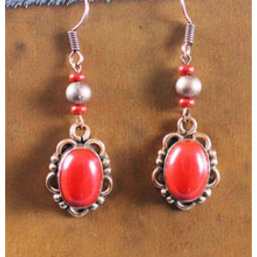 Copper tone and coral tone earrings dangle from a silver plate ear wire and made in America.