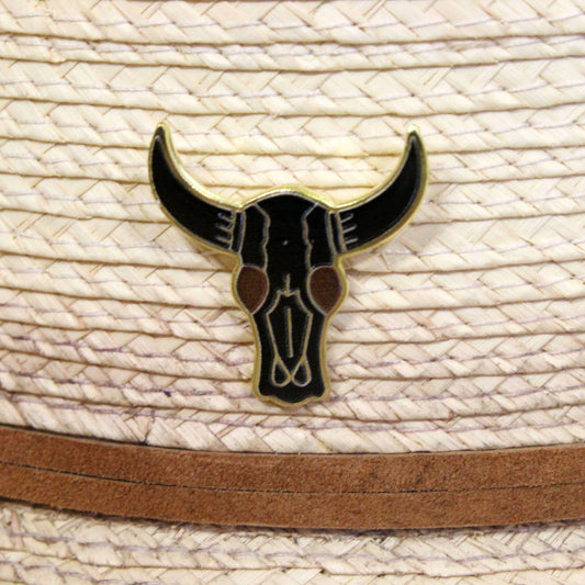 Black bull skull emblem on a straw hat with a brown band