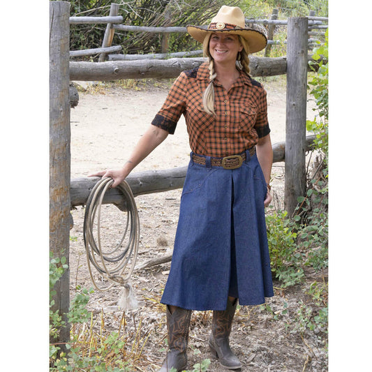 Our classic split Riding Skirt has been shortened and altered for this contemporary look for the western lady. The skirt has studded front yokes, belt loops and a front zipper closure. Our classic Riding Skirt features remain in this new design including pockets and elastic in the back waistband for a comfort fit. 100% Cotton 6oz. Denim. Approximately 32” Long. Made in USA. 