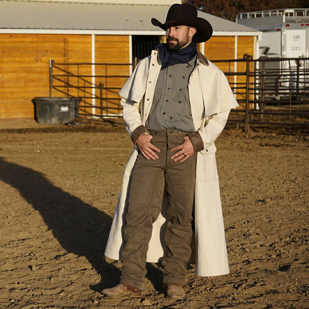 Weather the storm in our durable canvas cowboy duster. The classic style duster is used by cattlemen and ranchers to protect themselves from the elements. The long coat is made of heavy-duty canvas with leather cuffs and collar suitable for riding or general all purpose use.