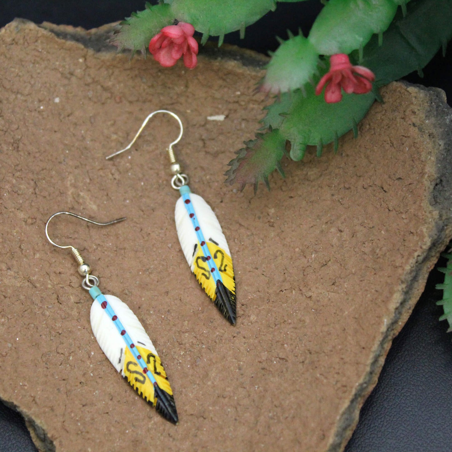 Made of bone and intricately painted to resemble a native spirit feather. Measures approx. .5″ across and 1.5″ from the base of hypoallergenic ear wires. Made in USA.