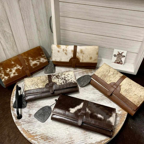 Grab hold of the Dakota spirit with the Dakota Hide Ladies Wallet. This handcrafted wallet stands out with its unique cowhide leather and custom one-of-a-kind look.