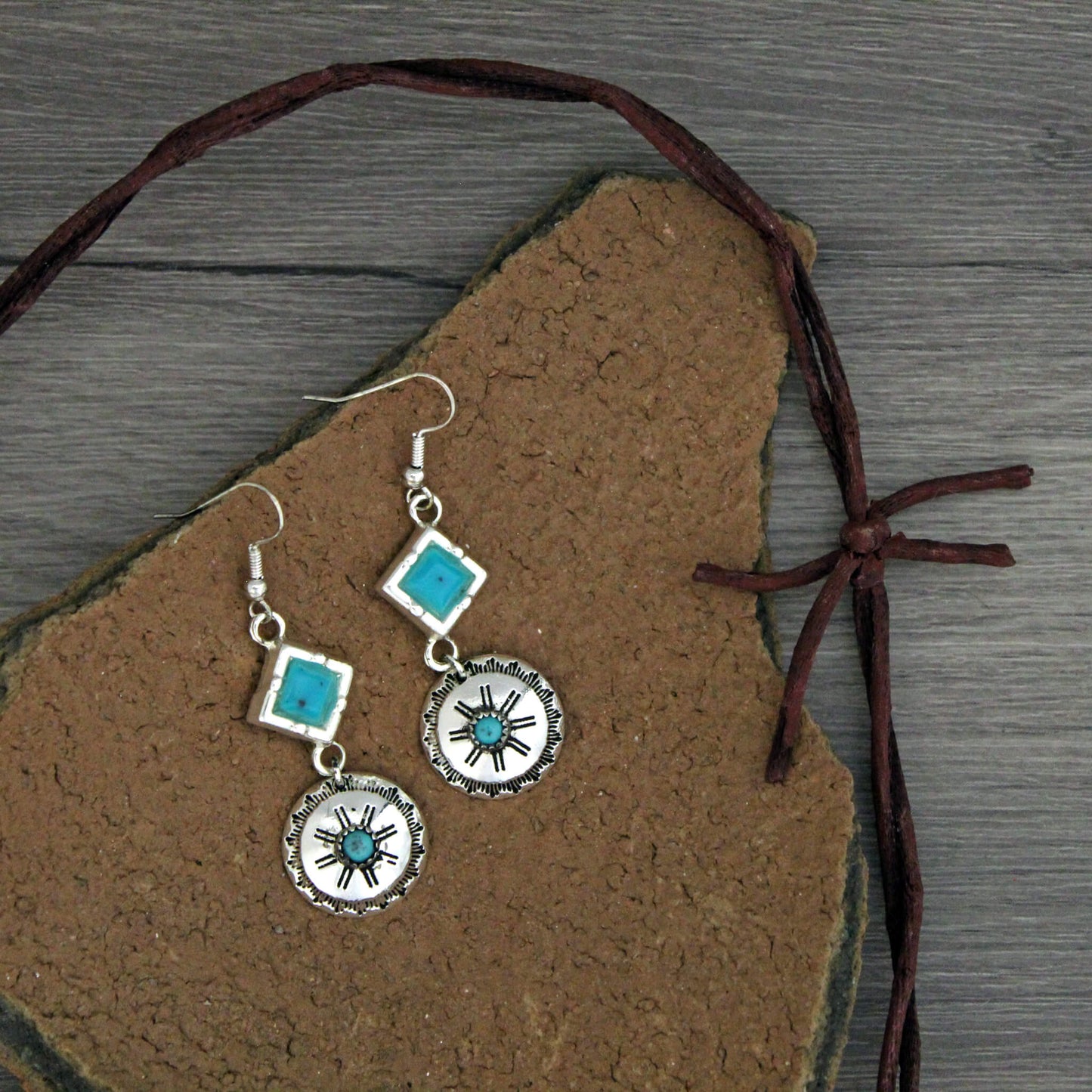 Flaunt your western flair with these long dangle earrings. They scream cowgirl fun with just the amount of vibrant turquoise that compliment's pretty much any color of the rainbow so it goes with any outfit you wear. Super Cute! They hang about 2" long and widest part is 3/4" diameter. Lead free. Hypo-allergenic.