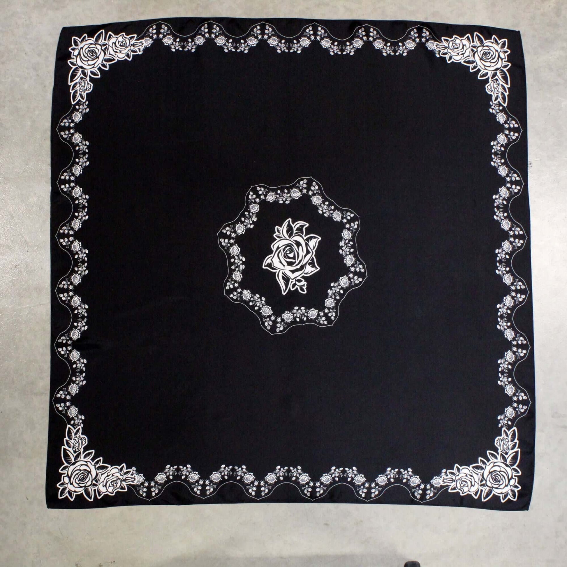 Desert Rose Black Silk Scarf showcasing white rose border and central motif on luxurious black silk