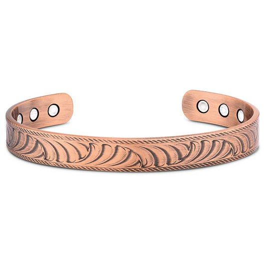 Copper bracelet with engraved design on a white background