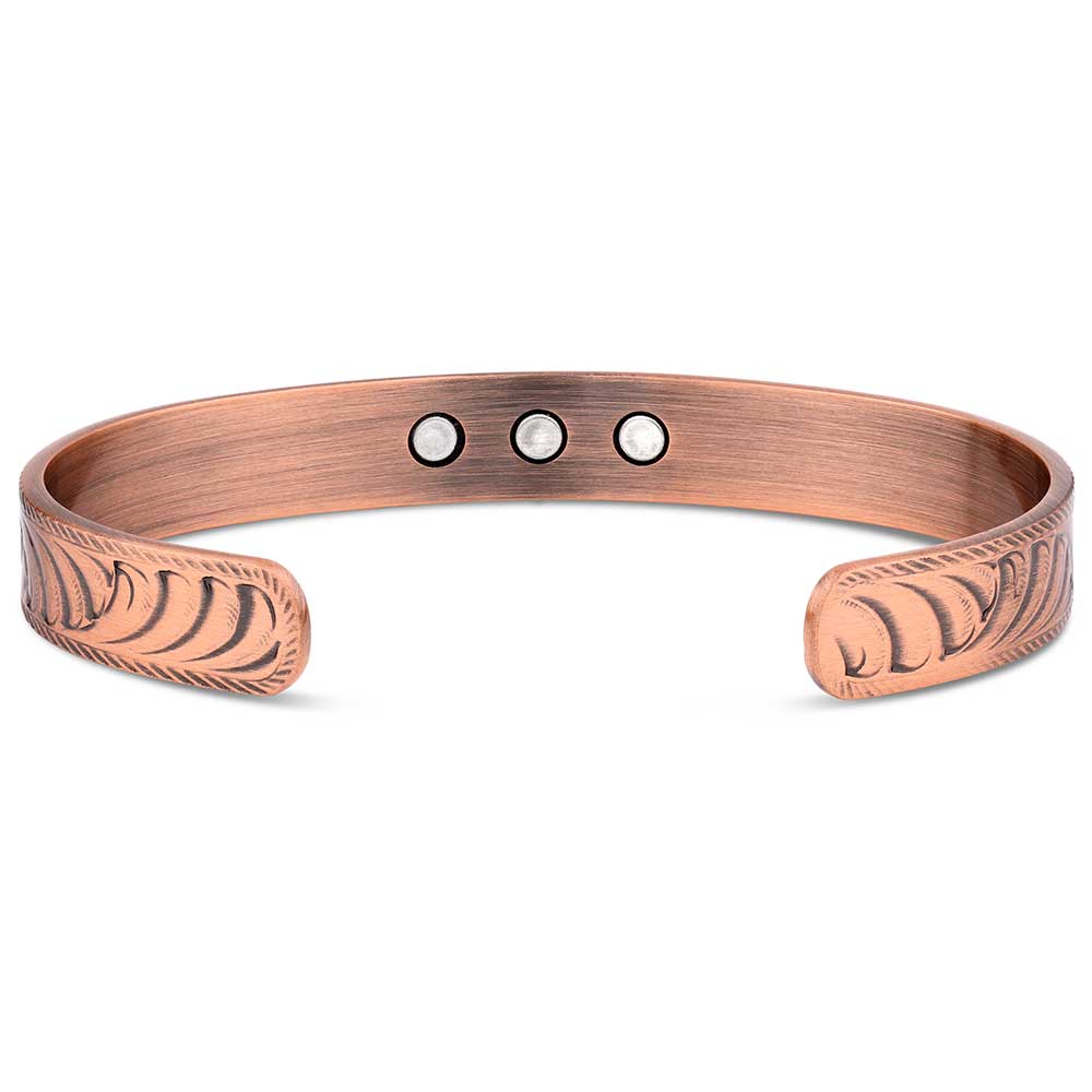 Copper bracelet with engraved design on a white background