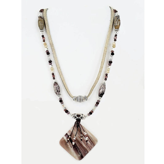 The pendant is Porcelain Jasper Stone measuring 2″ wide and 2″ long. Two strands with silver beads finish this look and measures 22″ including a 4″ extender and lobster claw clasp. Each piece is unique and may vary slightly.