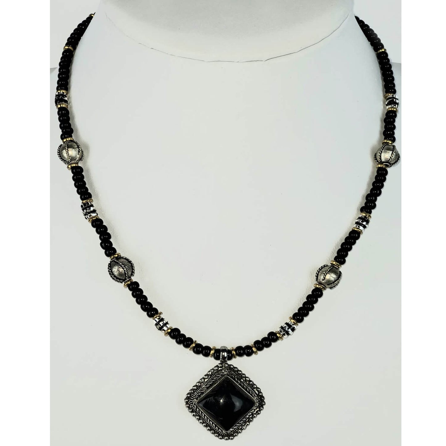 Black horn pendant 1″ square framed in antique silvertone with black and silver beads on a single strand. Measures 20″ including a 4″ extender and lobster claw clasp. Each piece is unique and may vary slightly. Made in USA.