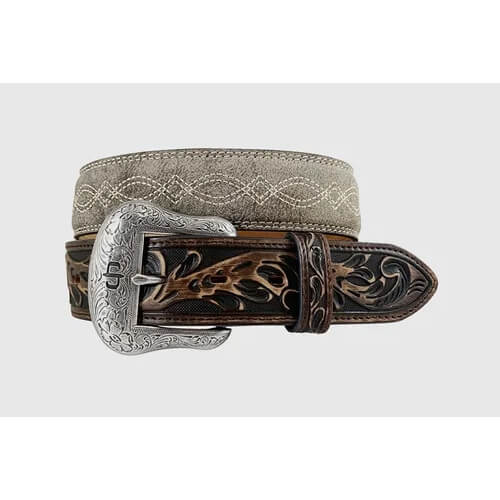 A western-style leather belt with a tooled brown strap, a light beige embroidered band, and a large engraved silver buckle, shown on a light gray background.