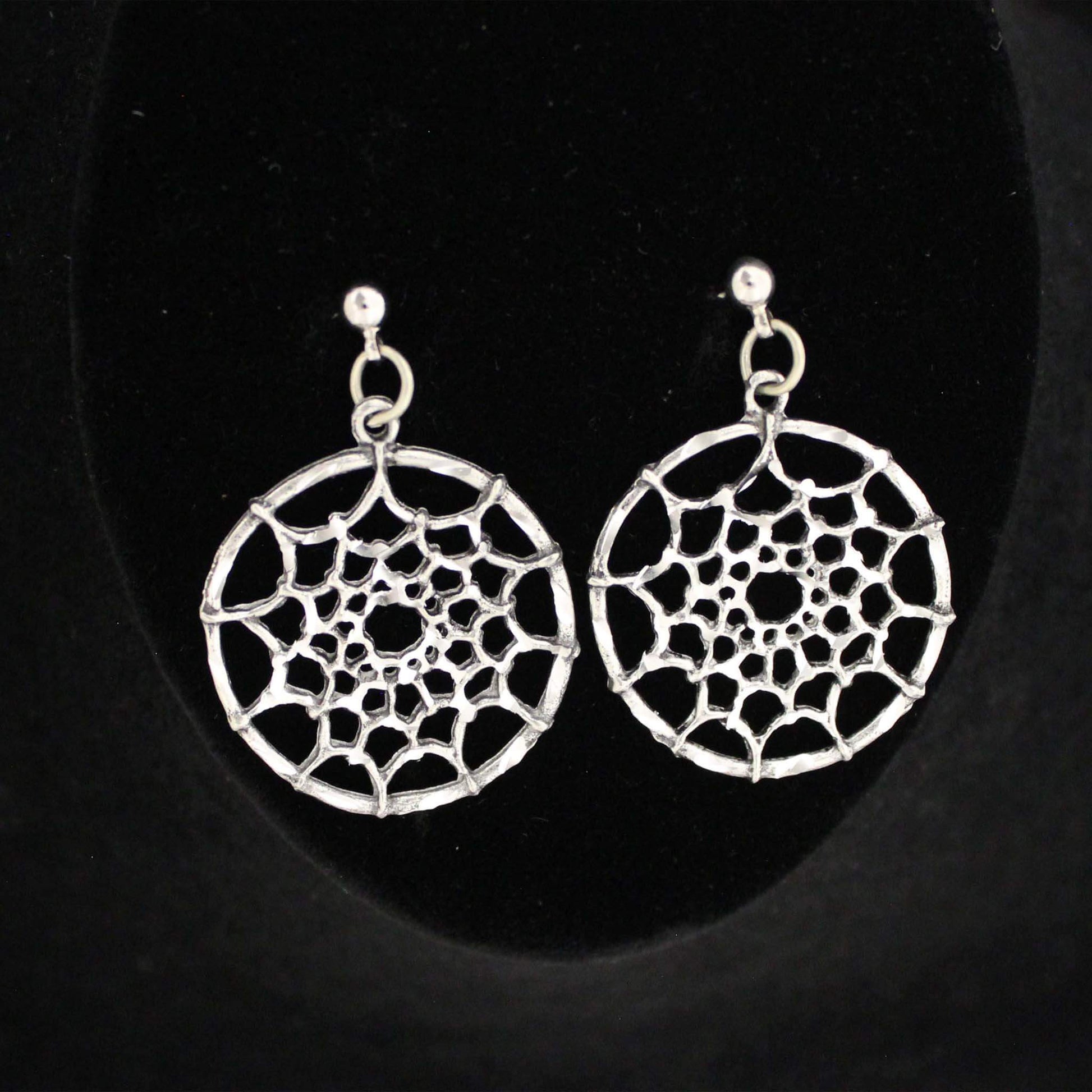 Dream catch Pewter Earrings you can dress them up or wear with your favorite jeans. Made of fine jeweler's pewter that is extremely lightweight and has a brilliant shine. Each piece is handmade and hand finished with diamond cuts. The sparkly cuts give each piece a unique dazzling sparkle. Approximately 1" diameter. Made in USA