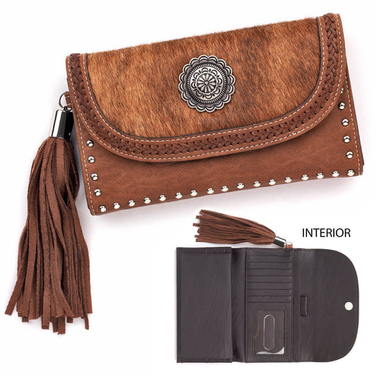 Beautiful western influenced Blazin Roxx flap over wallet. This classic wallet features faux calf hair, a large silver concho, and fringe. With multiple interior card slots and flap-over button closure this wallet defines the look of the true traditional western woman. &nbsp;