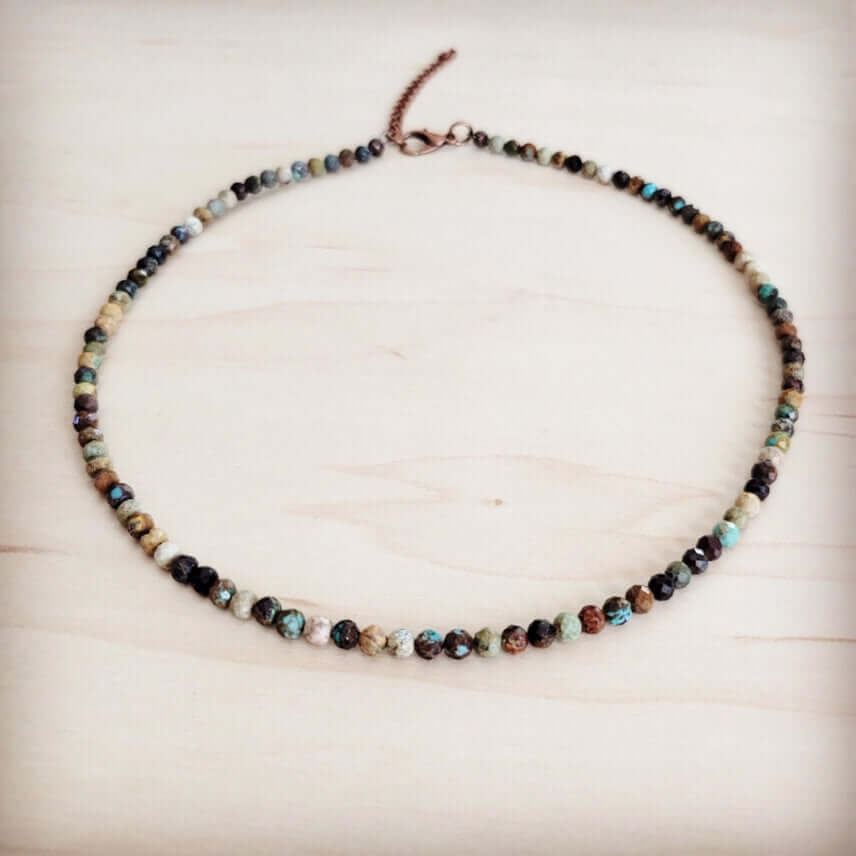 Necklace with multicolored beads on a light wooden surface