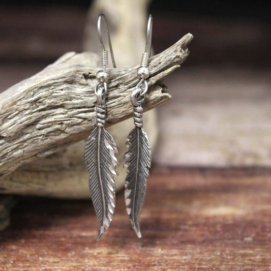 Handcrafted pewter feather earrings. These earrings are finished off with a diamond cut that makes them sparkle. Lightweight and beautifully designed. Measure about 1-3/4" long. Made in USA.