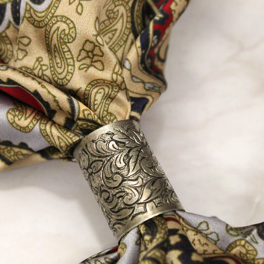 Here is a lovely scarf slide that will hold your neck garment in place and add a special fancy touch to your western cowboy scarves. If you need something to hold a scarf in place without having to knot it up, this simple tube style scarf slide will do the trick. Measures 1" long with .5" diameter.