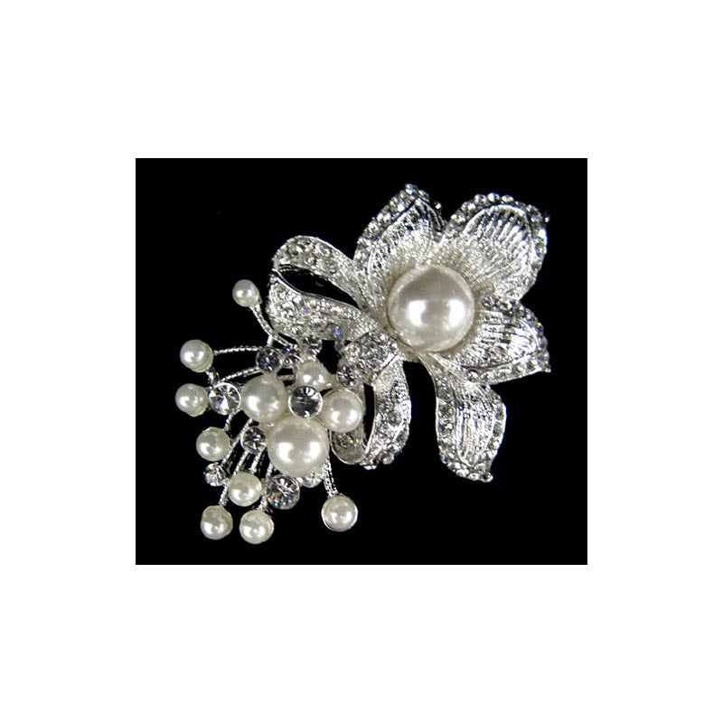 Add a brooch to your wedding outfit or as a clip on your bustle or even to secure a scarf while adding a fancy touch. This vintage style brooch is a silver flower, with pearls and rhinestone accents.