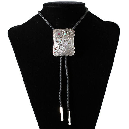 This exquisite silver necklace features a striking black leather cord, elegantly complemented by an antique silver bolo tie adorned with intricate floral engravings. The centerpiece showcases vibrant Turquoise, Siam, and Amethyst stones, adding a touch of color and sophistication. Measuring 36 inches in length, the black braided manmade cord is finished with antique silver tips, making it a perfect accessory for both casual and formal occasions. 2-1/4 Long x 1-3/4 Wide