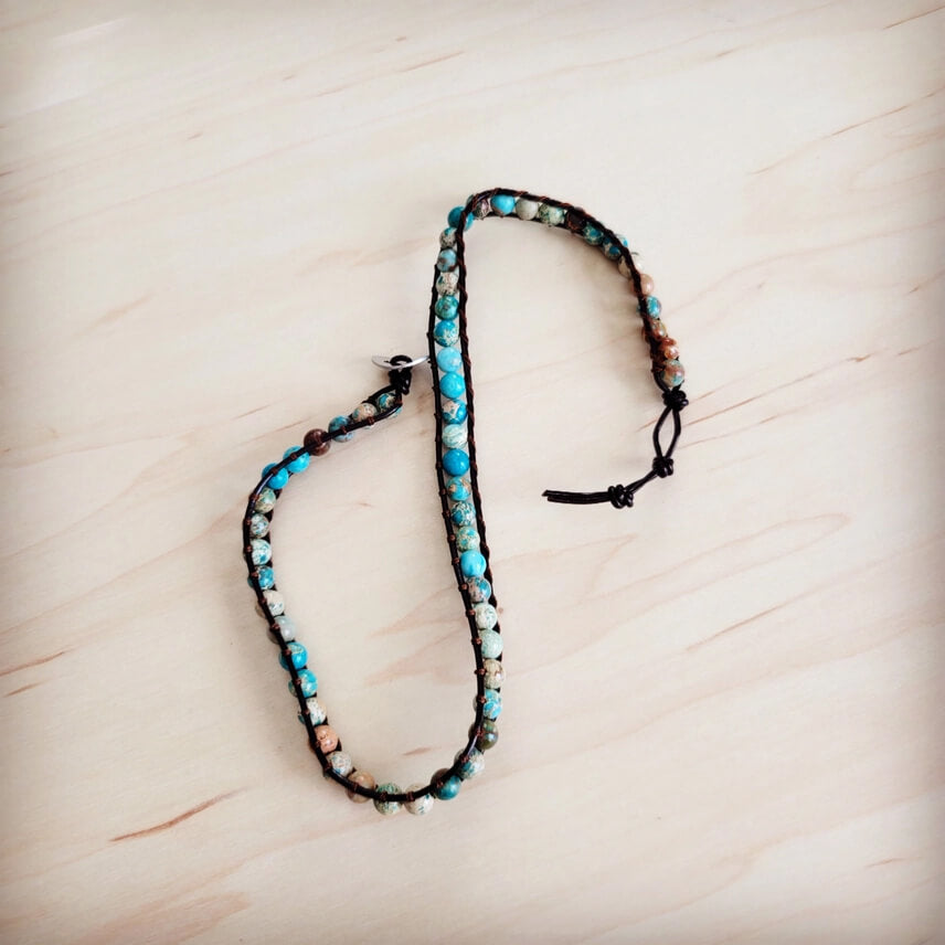 Bracelet with beads on a light wooden surface