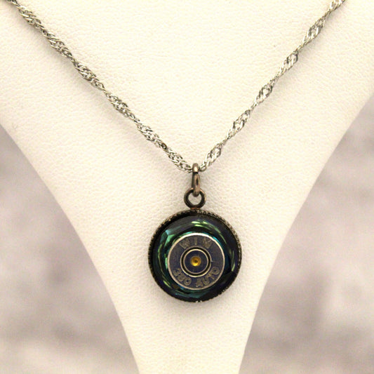 The genuine 38 auto bullet is artfully embedded in Swarovski crystals, transforming danger into dazzling beauty. Wear it close to your heart to channel courage, or show off your sharpshooting skills. The hefty 16-18 inch silver chain gives this medallion necklace a substantial look and feel worthy of your inner warrior. Be daring, be different, be you.