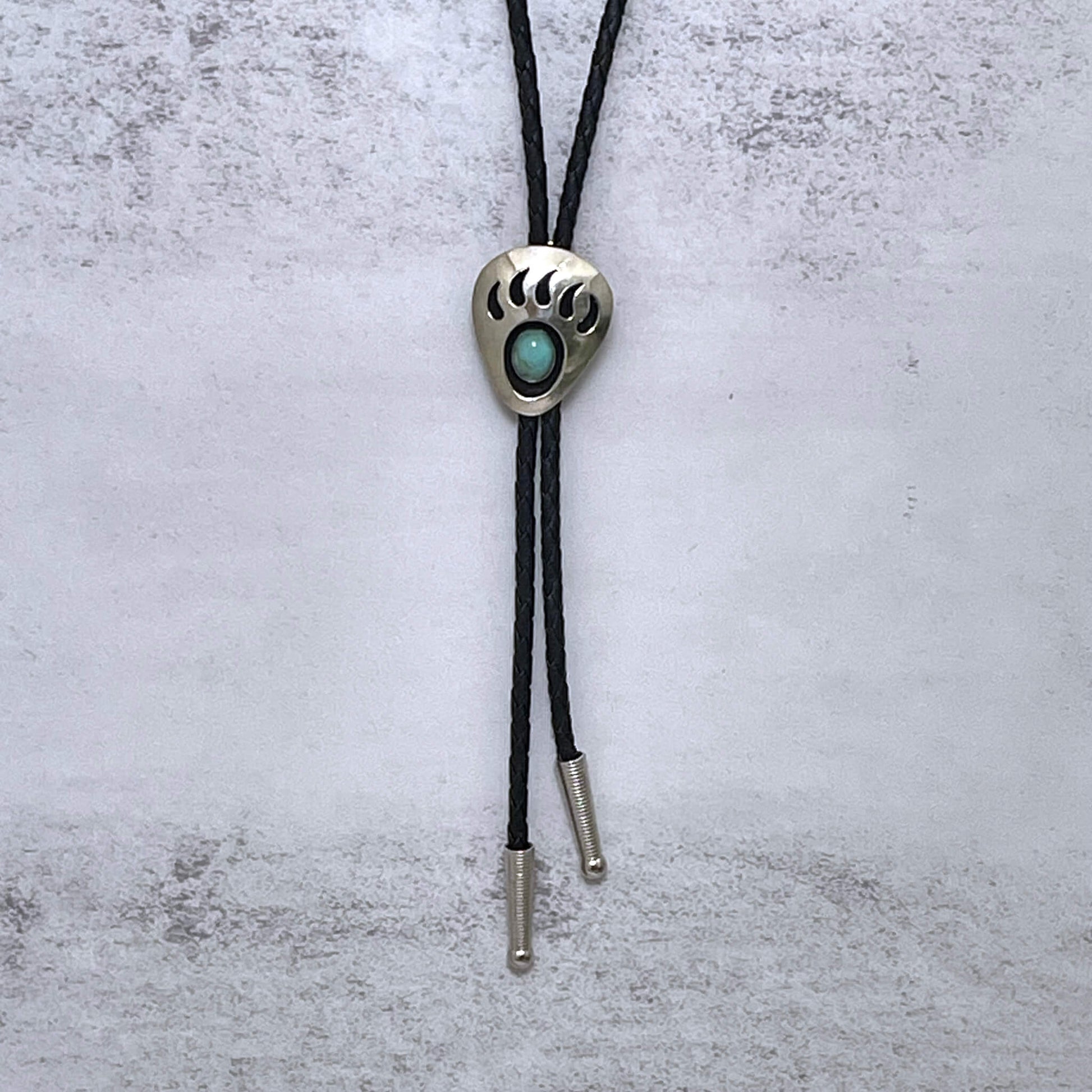 Very western style Grizzly claw with turquoise enamel incorporated into the claw print. Made in USA