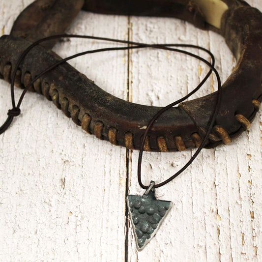 A necklace that's sharp in more ways than one. This Hammered Metal Arrowhead Necklace adds rugged western style to any outfit. With a hand-hammered arrowhead pendant on a genuine leather cord, it's the perfect accessory for the modern cowboy.