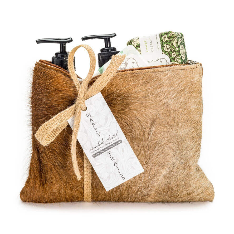 Brown fur pouch with skincare products and a tag on a white background