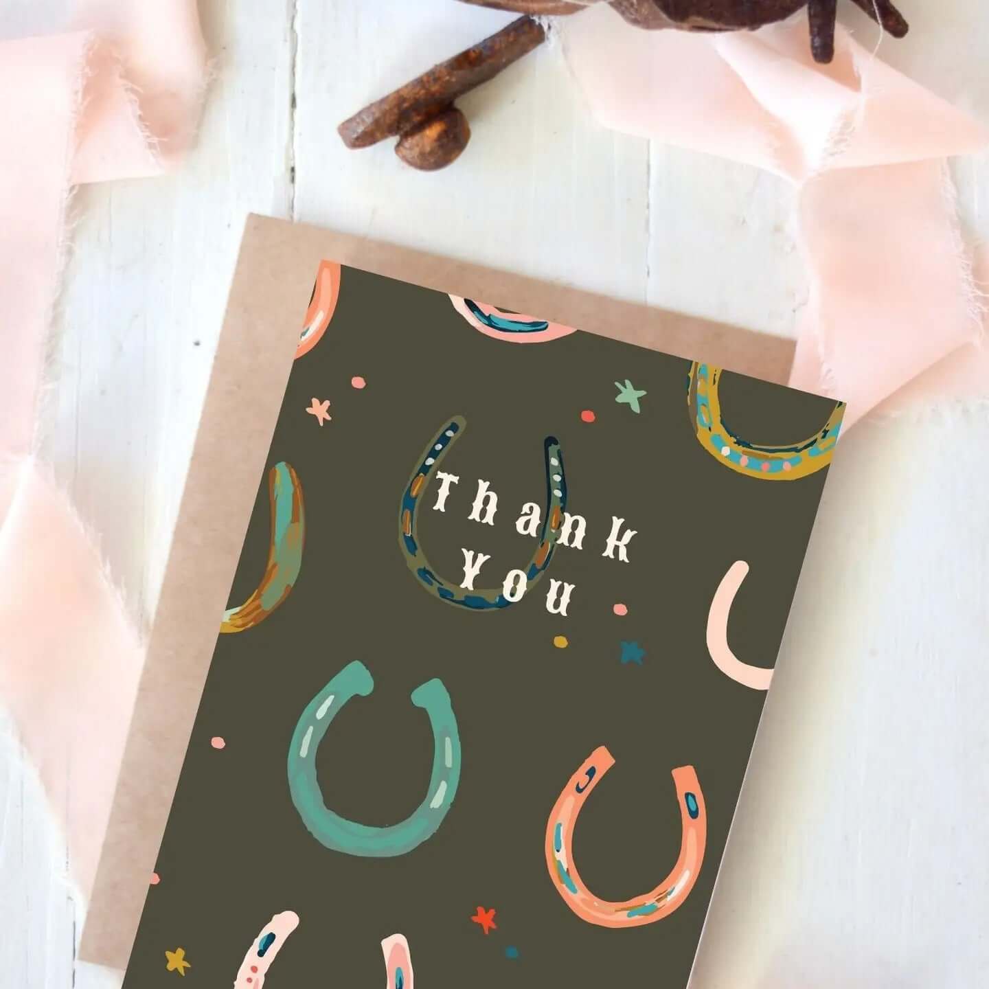 Cowgirl & Cowboy Western Greeting Cards Blank featuring colorful horseshoes and a thank you message.