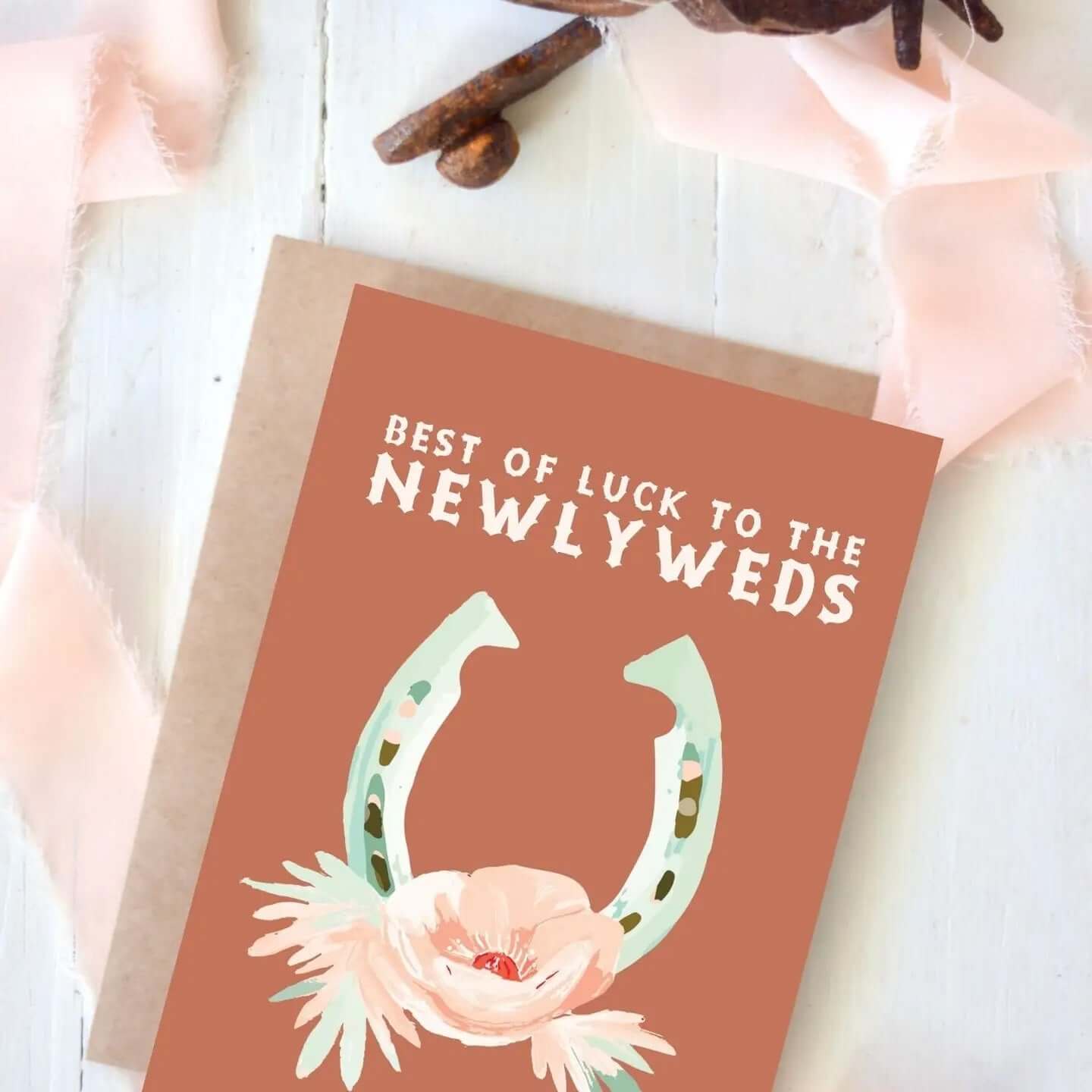Best of Luck to the Newlyweds greeting card featuring a horseshoe and floral design.
