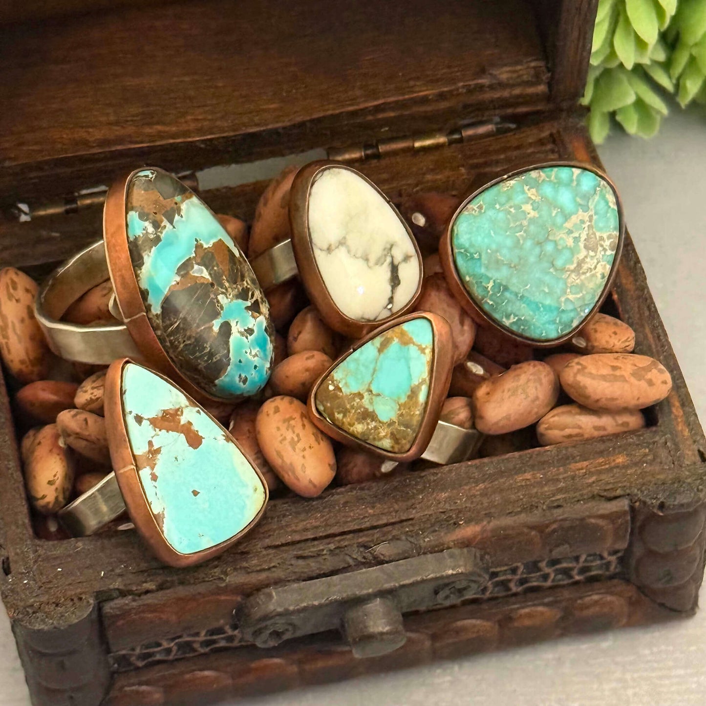 Set of rings with turquoise stones in a wooden box