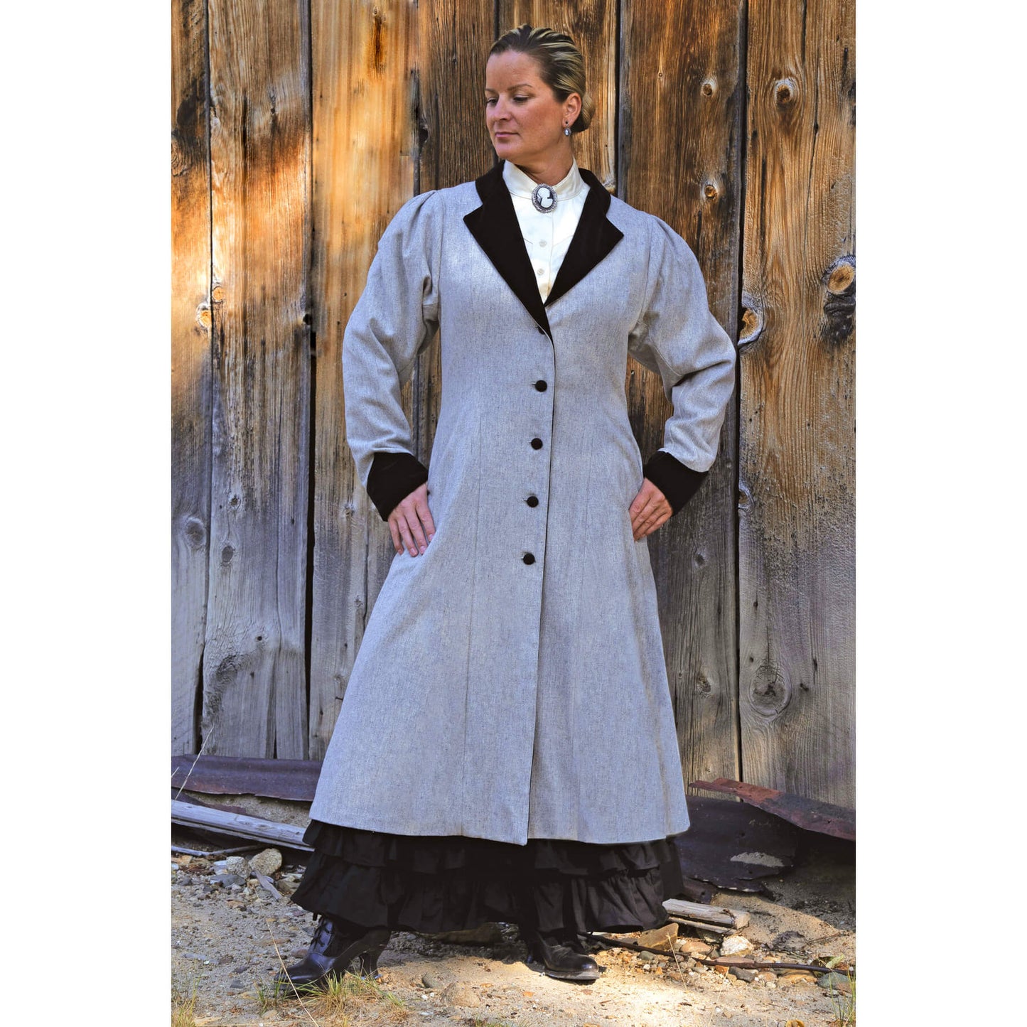 During the 1800’s women’s dresses were full and the sleeves were big. They required a large overcoat. Embrace the charm of the Victorian era in this exquisite long vintage coat. Sleeve tucks dramatize the silhouette and black cotton velvet contrasts on the light heather grey wool with pleats in the back and angled cuffs. 100% Wool and lined in a heavy Satin Flannel Polyester. Dry Clean. Made