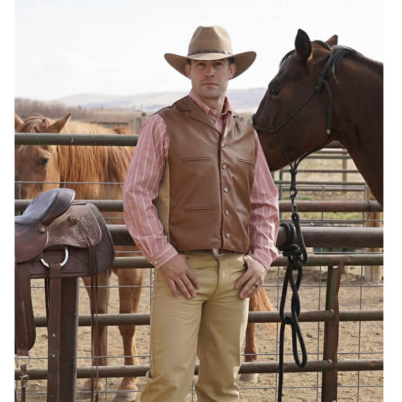 This classic style vest is inspired by the original “Duke Vest” that was made popular by John Wayne. The vest is made of quality leather in the front, back yoke and back adjustable belt and a canvas back. Designed for rugged good looks and classic western style. This handsome vest features a notched lapel, four welt pockets and finished with 5 antler buttons. What a terrific way to honor the Duke and look great at the same time! Made in the USA.