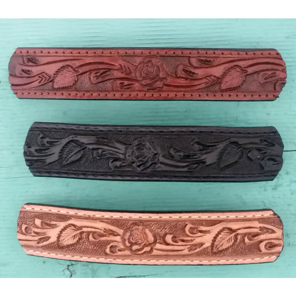 These leather barrettes are embossed with a floral design create the perfect finishing touch to an effortless hairstyle. Choose from black, brown and tan or get all three so you have one for any outfit. Approximately measures 4" Long by 3/4" Wide.