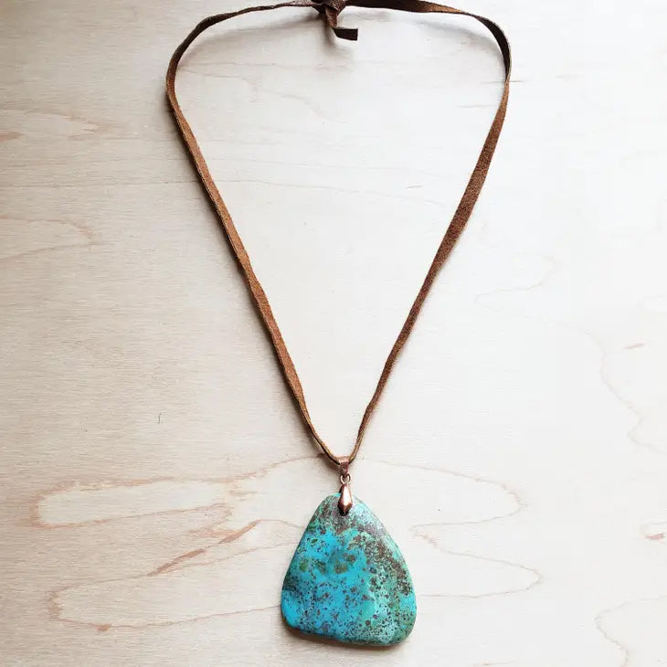 Genuine Leather Necklace is accented with a pendant of genuine Natural Turquoise. Great for layering or as a statement piece. The entire length of necklace is 24 inches Self-tie closure can be adjusted as needed. Pendant will vary in size from 1"-2" Although your item will resemble the photo, each piece is created by hand, so no two are identical. Made in USA