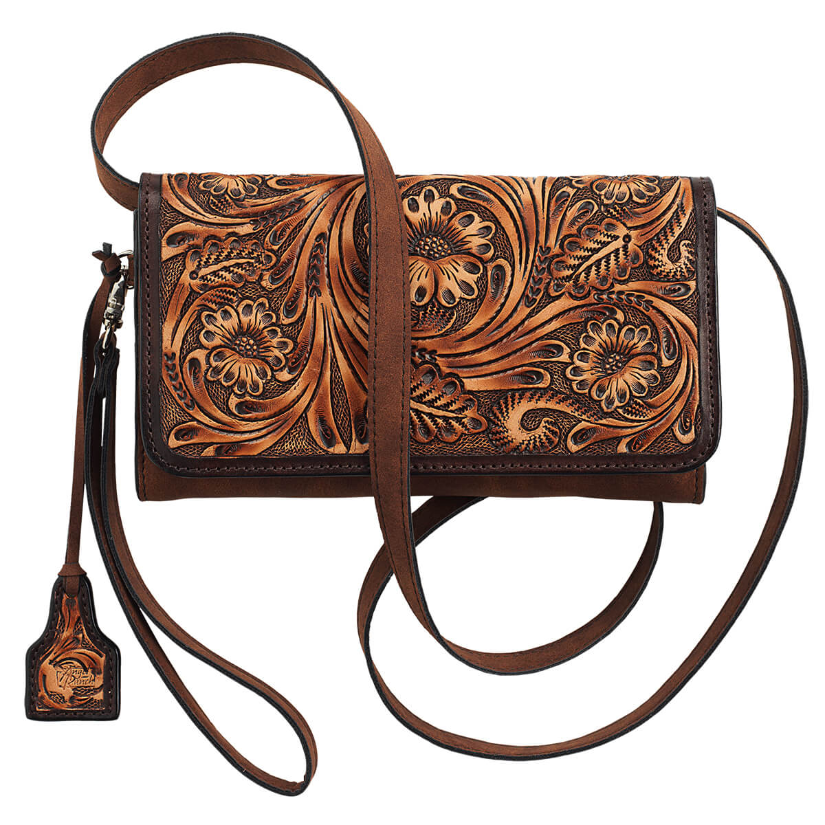 A brown leather crossbody wallet bag with intricate floral tooling on the front flap, featuring a matching leather strap and a decorative hanging tag, shown against a plain white background.