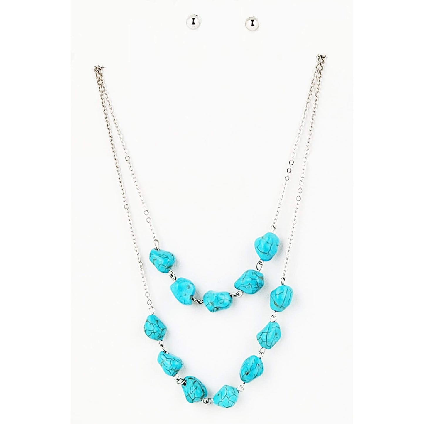 A simple double strand layered silver chain necklace embellished with magnesite turquoise. Measures 31″ with lobster claw clasp and extension chain and hypoallergenic silver tone earrings finish the set.