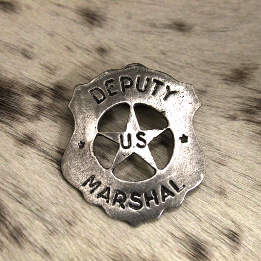 This type of badge was worn by the infamous Earp brothers, Wyatt and Virgil. This is also the type of badge worn by James Arness as Matt Dillon in the television series Gunsmoke.  Made just like those from the past. Cast pewter with awesome detail. Antique silver finish. Measures 2 5/8" tall by  2 1/8" wide. Comes displayed in an old west card. Proudly made in the USA. 