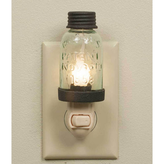 Add to your farmhouse style wit the Mason Jar Night Light. Perfect in a bath, bedroom or a hallway. Night lights provide comfort and safety. Measures 7" x 3". 5 watt bulb included. Mason Jar night light appliance. Candle-Lite bulb and appliance are included. Put the nostalgia of the old west in your home. 1¾" x 5"