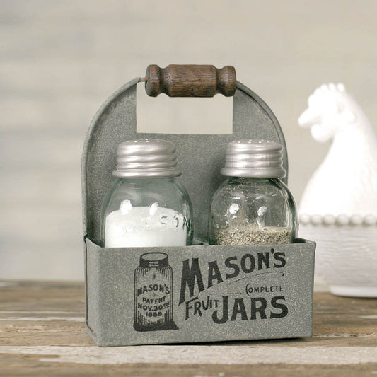 This charming Mason jar caddy measures 4" wide, 2" deep and 5½" tall to top of handle. This caddy holds one salt and pepper shaker set with the classic Mason jar logo printed on the front. A wooden handle adds a rustic touch. Glass Mason jar salt and pepper shakers are included. Measurement:4''W x 2''D x 5½''H