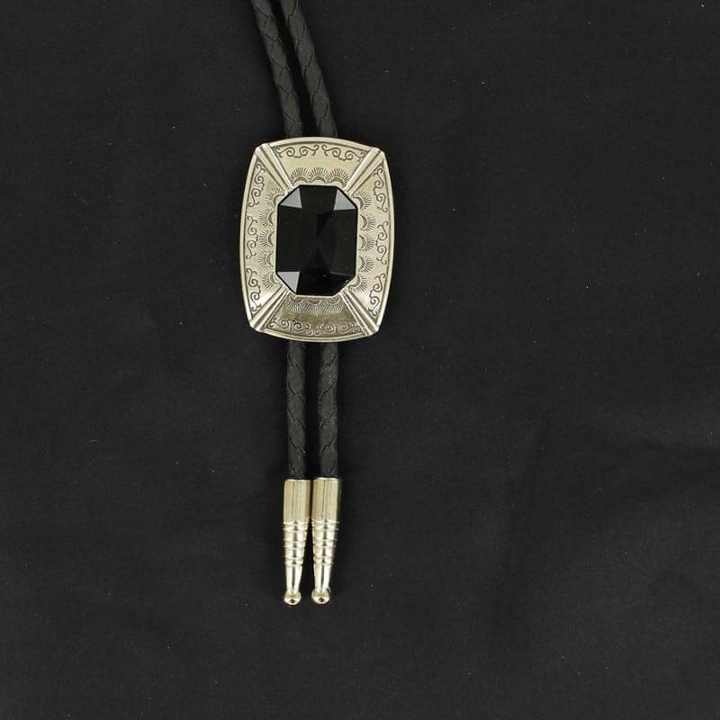 This Bolo tie has a silver rectangle engraved with detail and a black centered stone.  This handsome bolo tie is a great addition that will go with many different attires. 