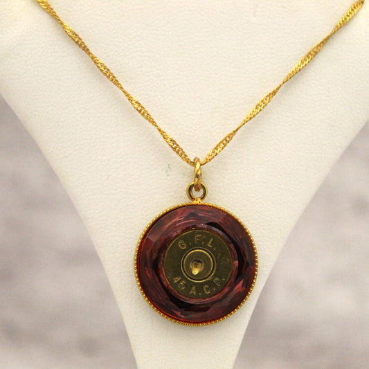 Make a statement with the eye-catching pendant, featuring a reddish-orange Swarovski crystal with a glinting bullet inside. The unique medallion design is sure to get attention and compliments. The fine 16-18 inch gold chain allows you to wear it at multiple lengths to suit your style.