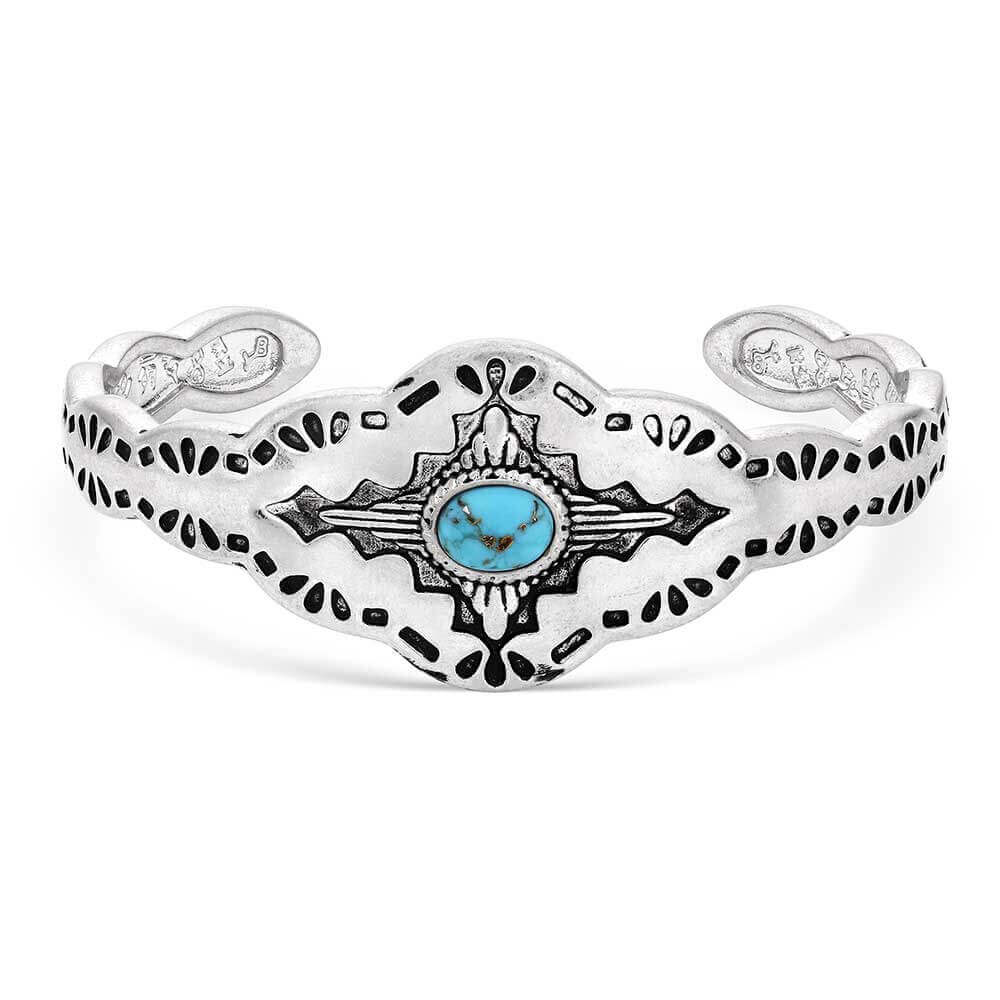Montana Skies Turquoise Cuff Bracelet featuring a turquoise stone on a silver tone base with etched Southwestern design.