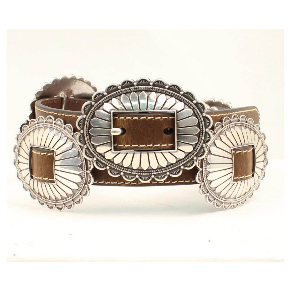 This simple and classic ladies belt is a must have for your closet. It features a thin brown strap with large oval floral silver conchos and a matching buckle. The contrast stitching really makes this belt pop with style. This quality belt will look good with any outfit, and will surely be your favorite.