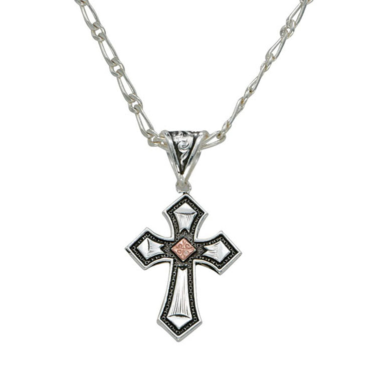 A tiny but intricately designed cross featuring a copper diamond square in the center of a bright silver cross, outlined with darkly antiqued stippling. Hung from an antiqued filigree bale on a 18" figaro chain. Cross pendant measures approximately 1" wide by 2" long.