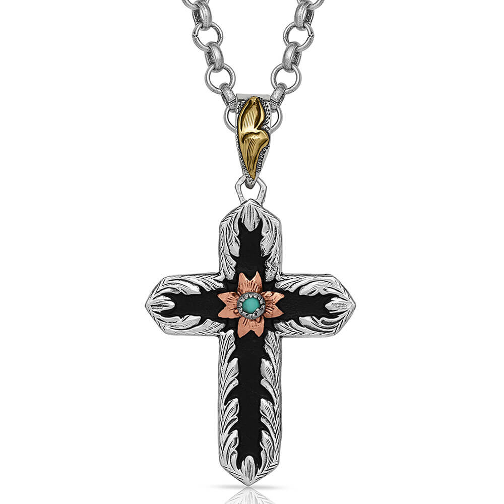 Two-Toned cross German silver necklace has a black overlay that contains a copper-toned small flower in the center holding a small turquoise stone. It dangles from a 28" chain. Pendant measures 1.25 x 2.35.&nbsp;