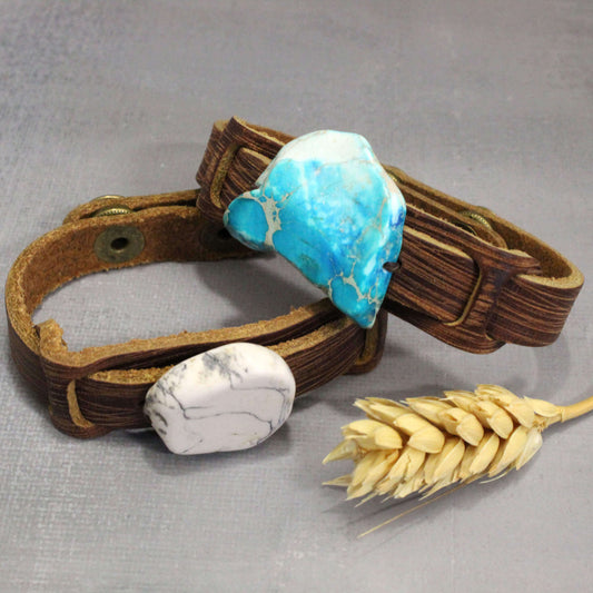 Brown leather bracelet with turquoise and white stones on a gray background