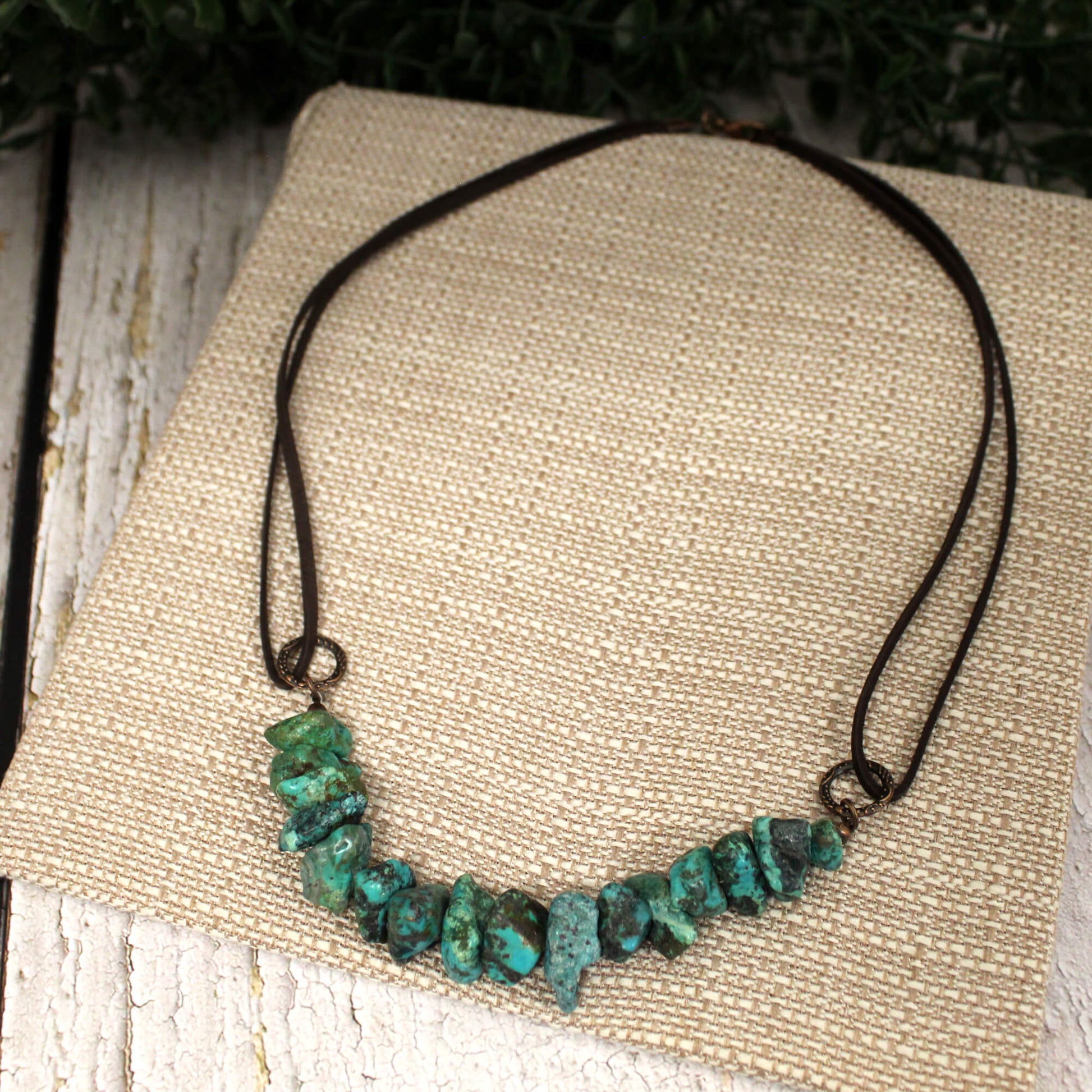 Beautiful genuine Natural Turquoise Stones make up this adjustable necklace on genuine leather cord. Adjusts from 18" to 20" with extender. Great for layering or as a statement piece. Made in USA