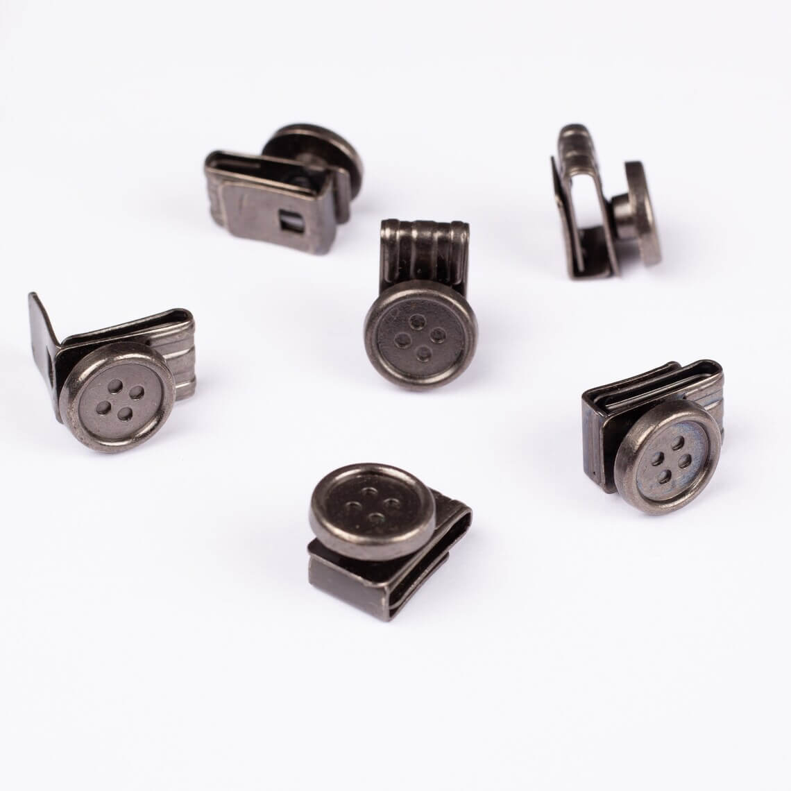 Set of metallic buttons for suspenders on a white background