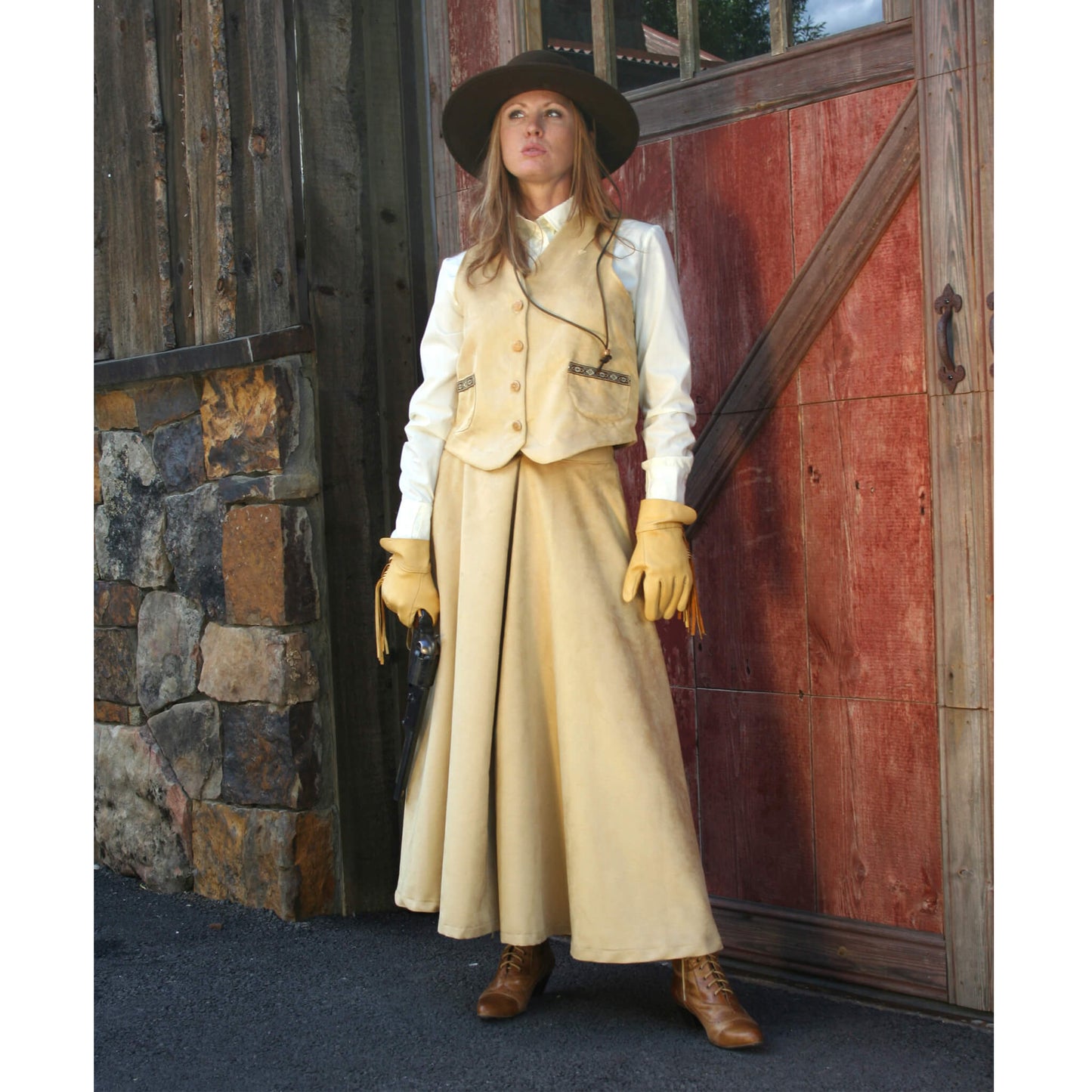 Our classic Riding skirt made of polyester suede in a golden buckskin color with a matching vest. The split Riding Skirt is cut wide with pleats in the front and back with elastic in the back waistband for an easy fit. It zips in the back with a button on top and has two side pockets. Approximate length 35" 100% Suede Polyester. Dry Clean Recommended. Made in USA