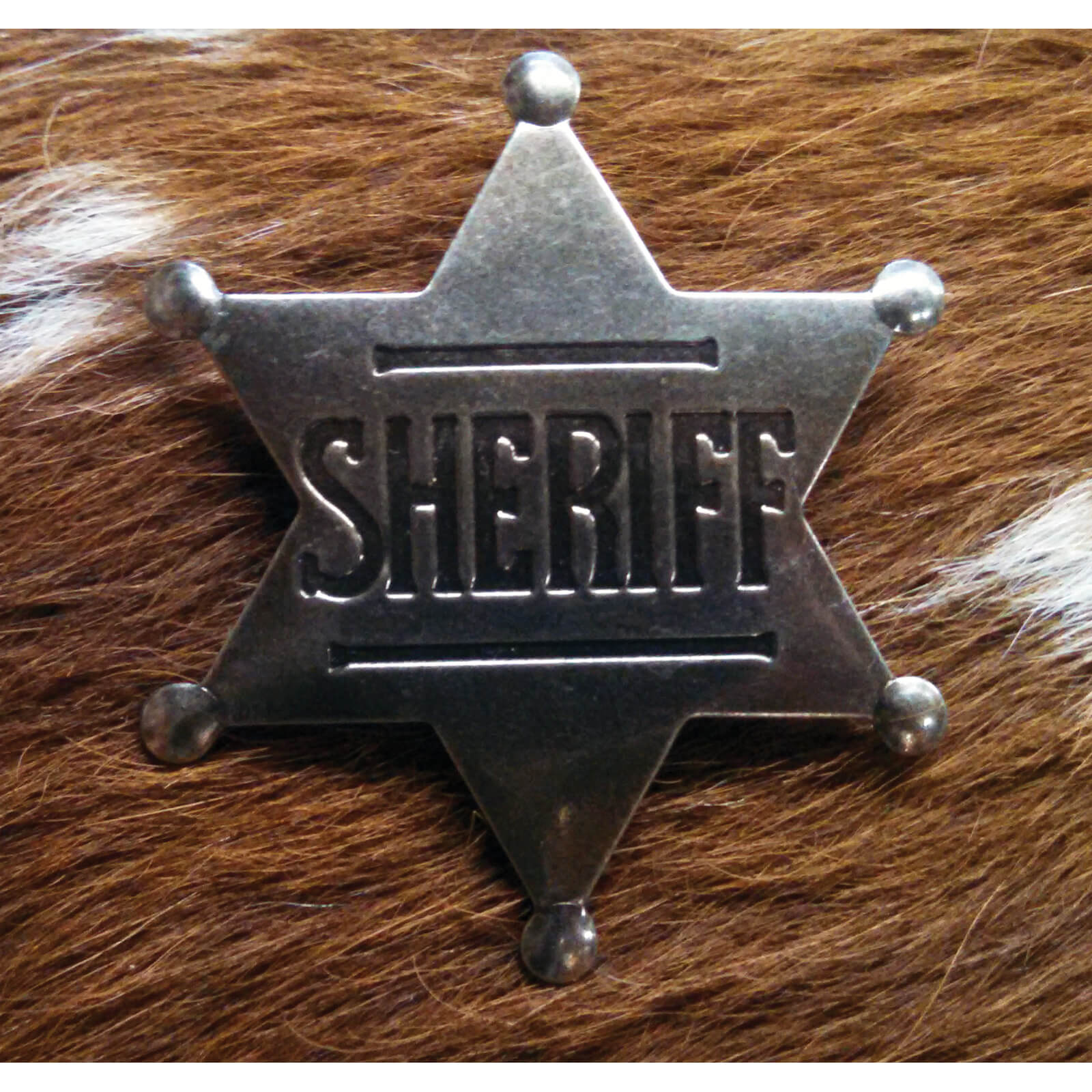 Traditional sheriff's six pointed star is high quality replica in authentic stamped steel, with rustic finish and back pin. Measures approximately 2 1/2" high.