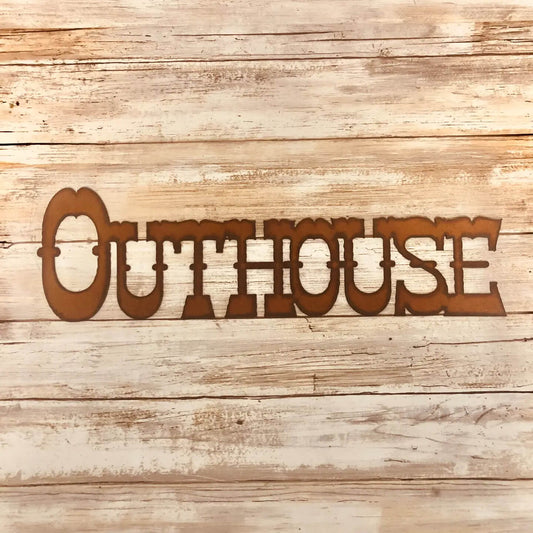 A laser-cut metal wall sign spelling 'OUTHOUSE' in a rustic brown color, displayed against a light-colored, weathered wood plank background.
